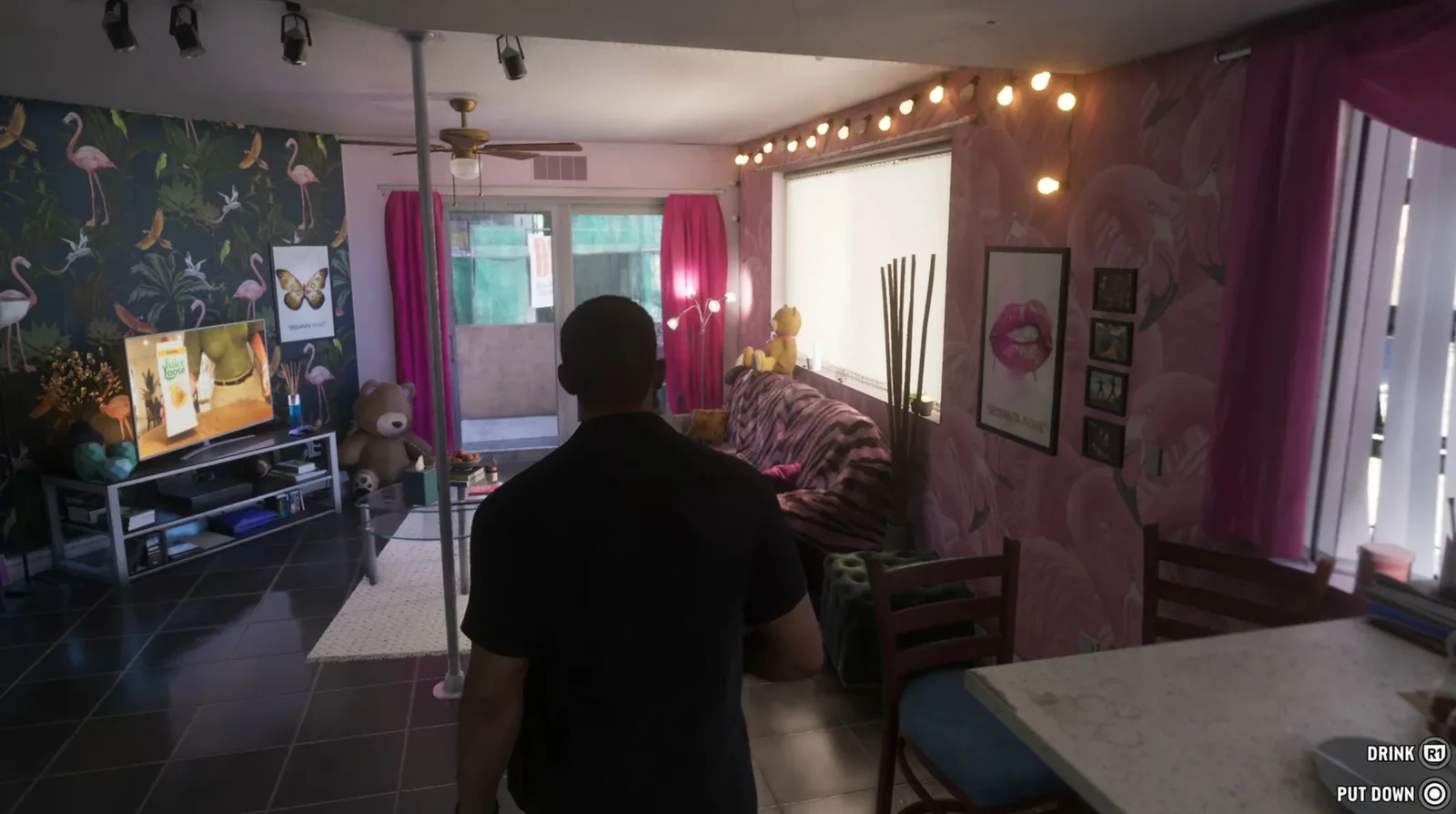 A motel room interior with flamingo wallpaper and a drink prompt on screen in GTA 6