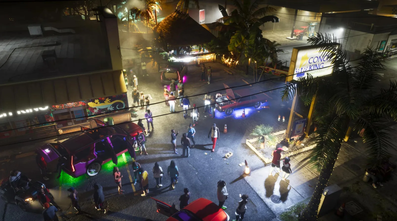 A night-time crowd of NPCs gathers around lowriders outside neon-lit Vice City clubs in GTA 6