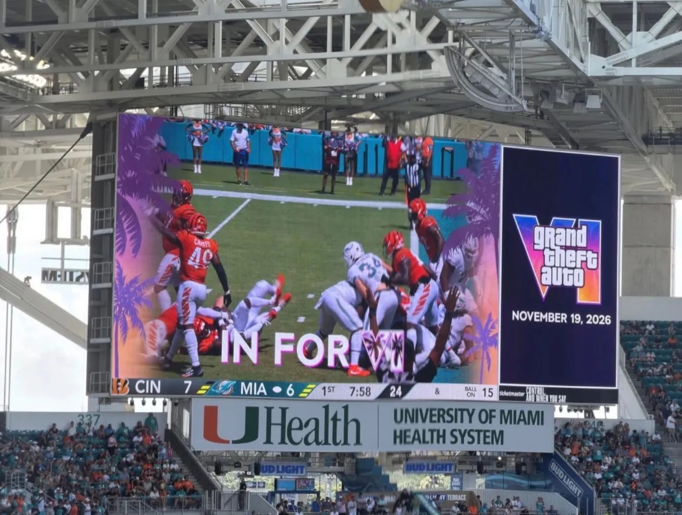 Hard Rock Stadium jumbotron showing an In for VI graphic with palm trees during Dolphins vs Bengals, with a GTA VI November 19 2026 panel beside it