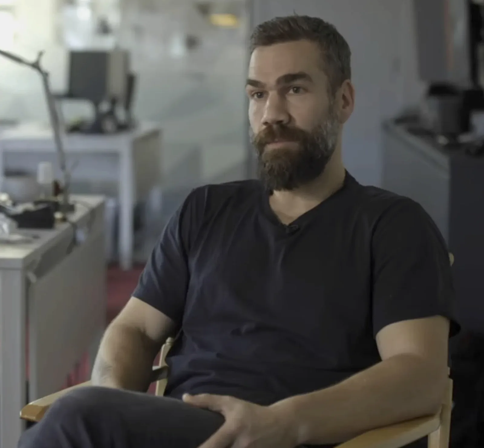 Rob Nelson seated in a chair during the IGN interview at Rockstar North