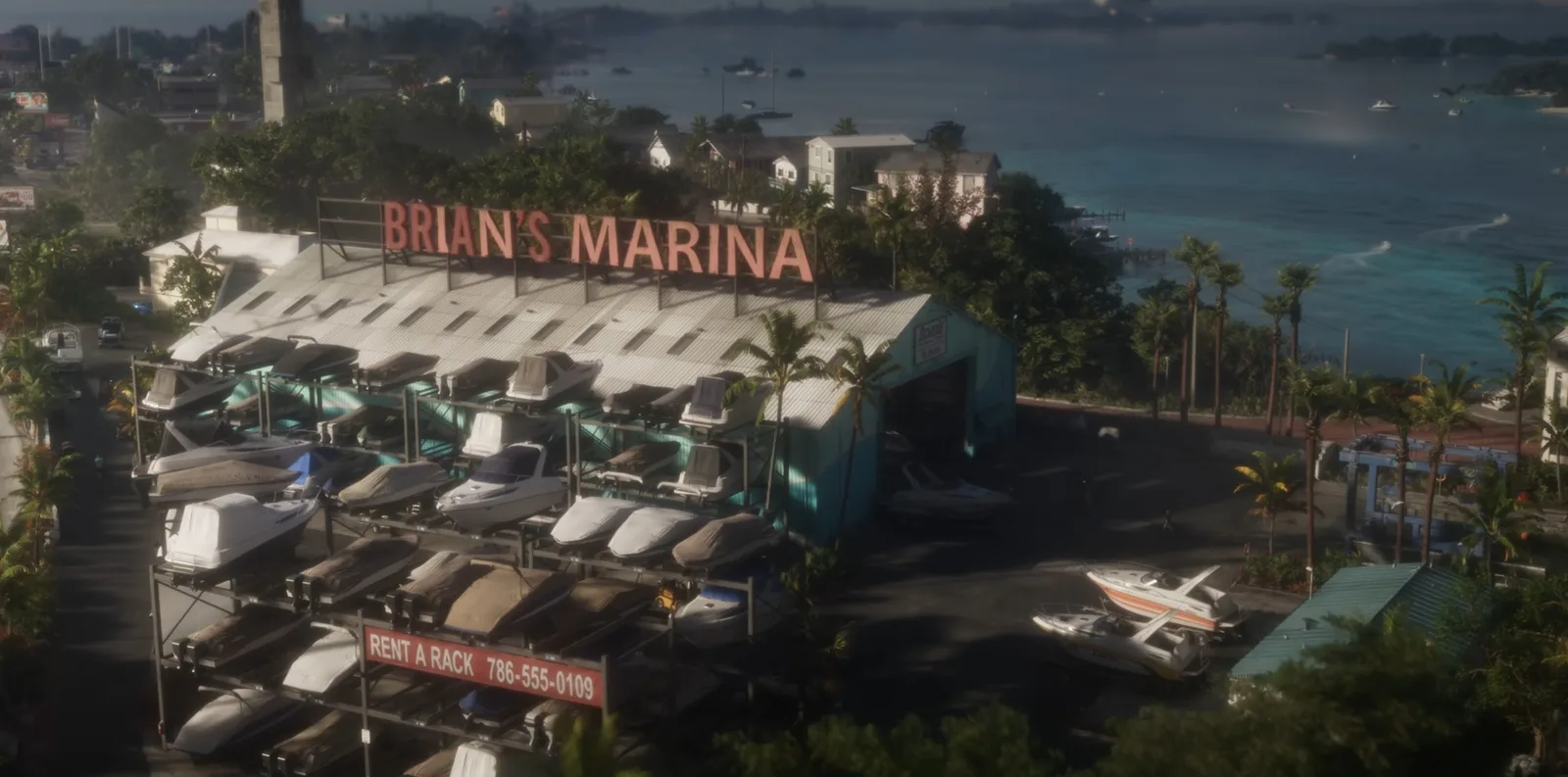 Aerial view of Brian’s Marina in GTA 6 with stacked boat racks, a Rent a Rack sign and the bay stretching behind
