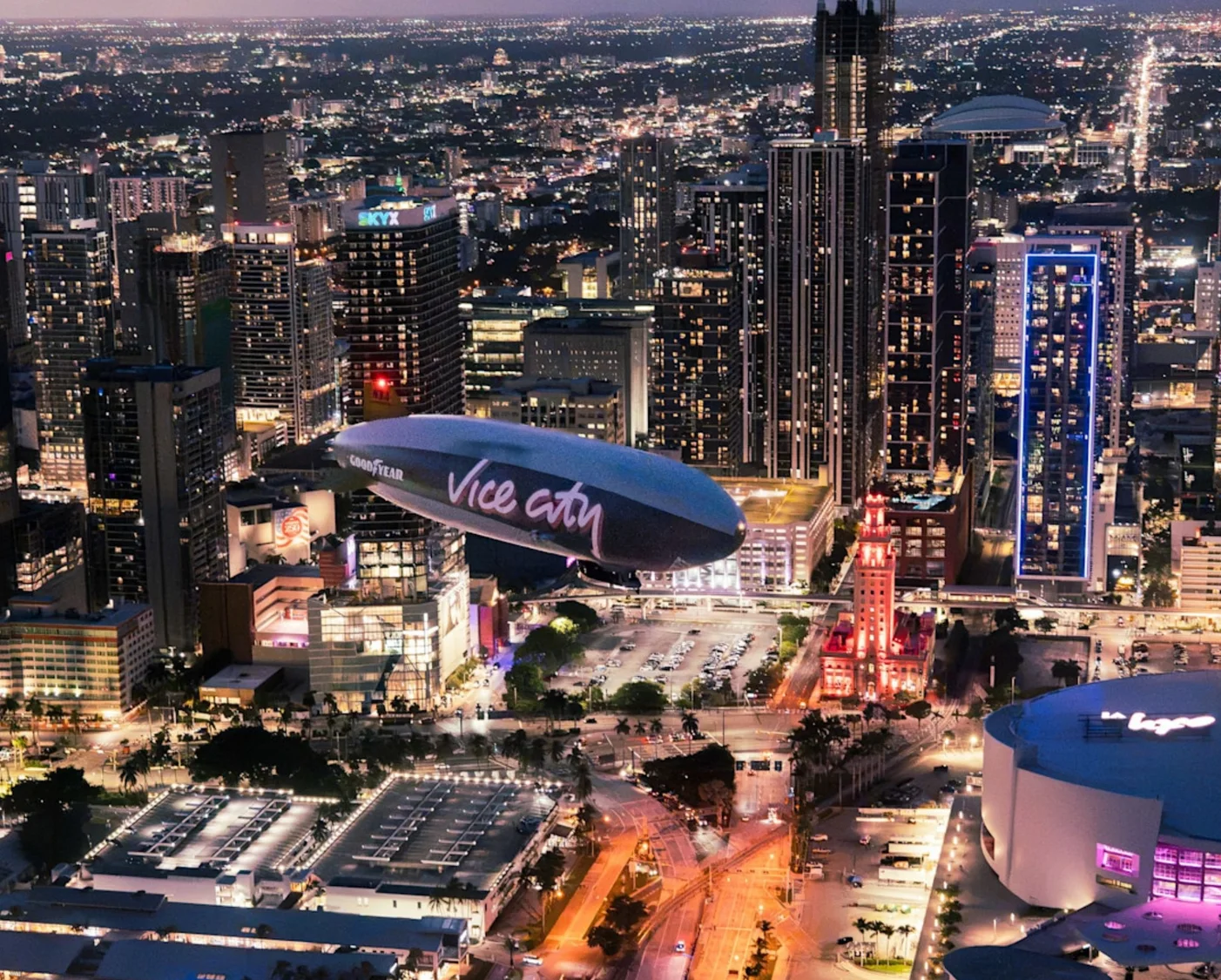 Vice City blimp flying over the neon downtown skyline at night in GTA 6