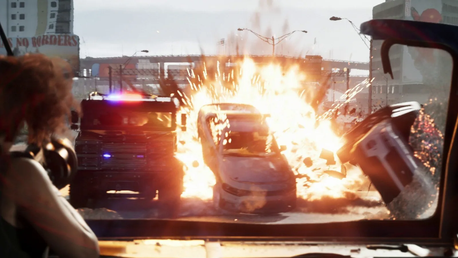 First person view from a truck cab as a car explodes beside a police van on a Vice City street in GTA 6