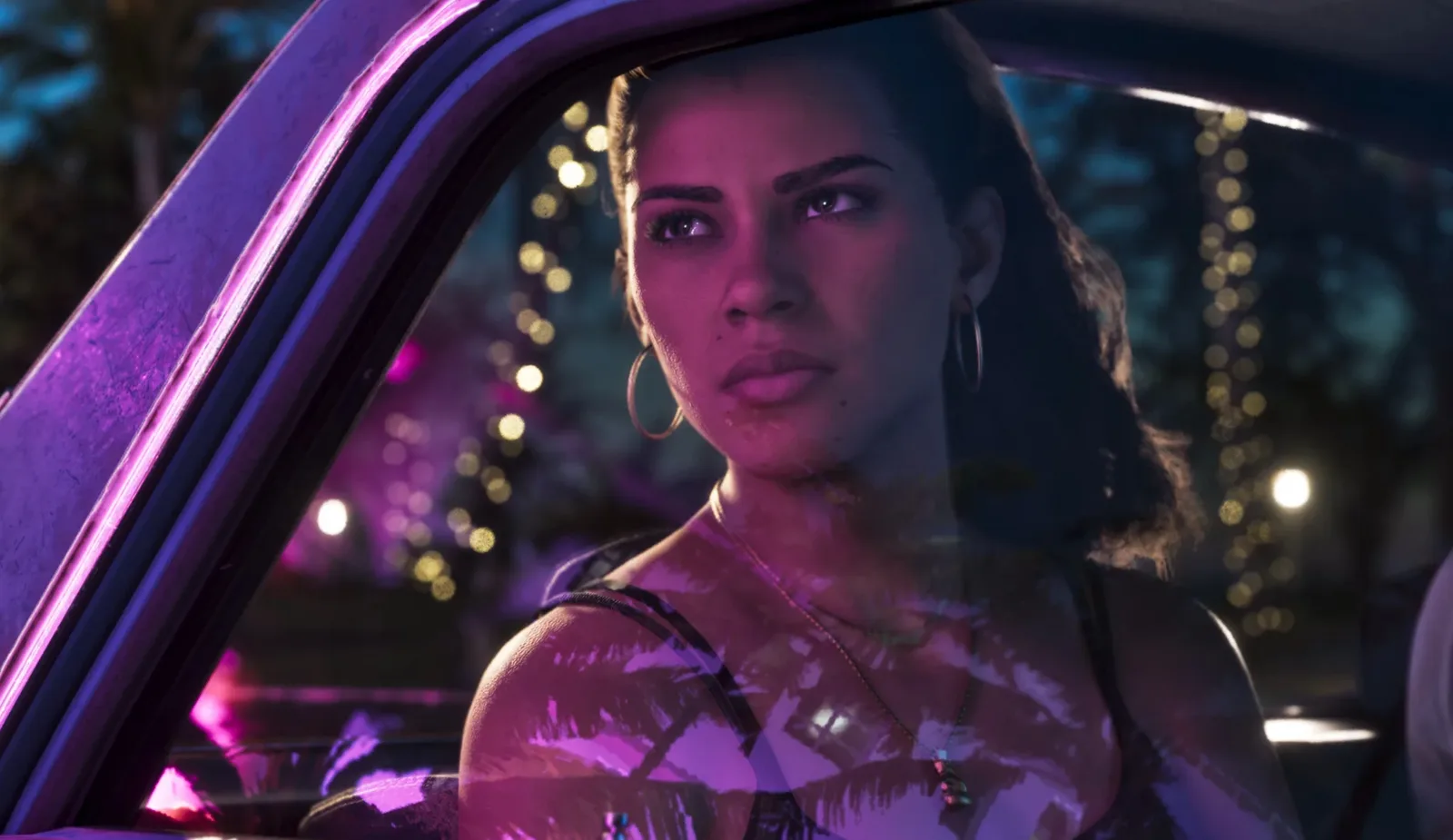Lucia looking out of a car window at night with fairy lights reflected in the glass in GTA 6