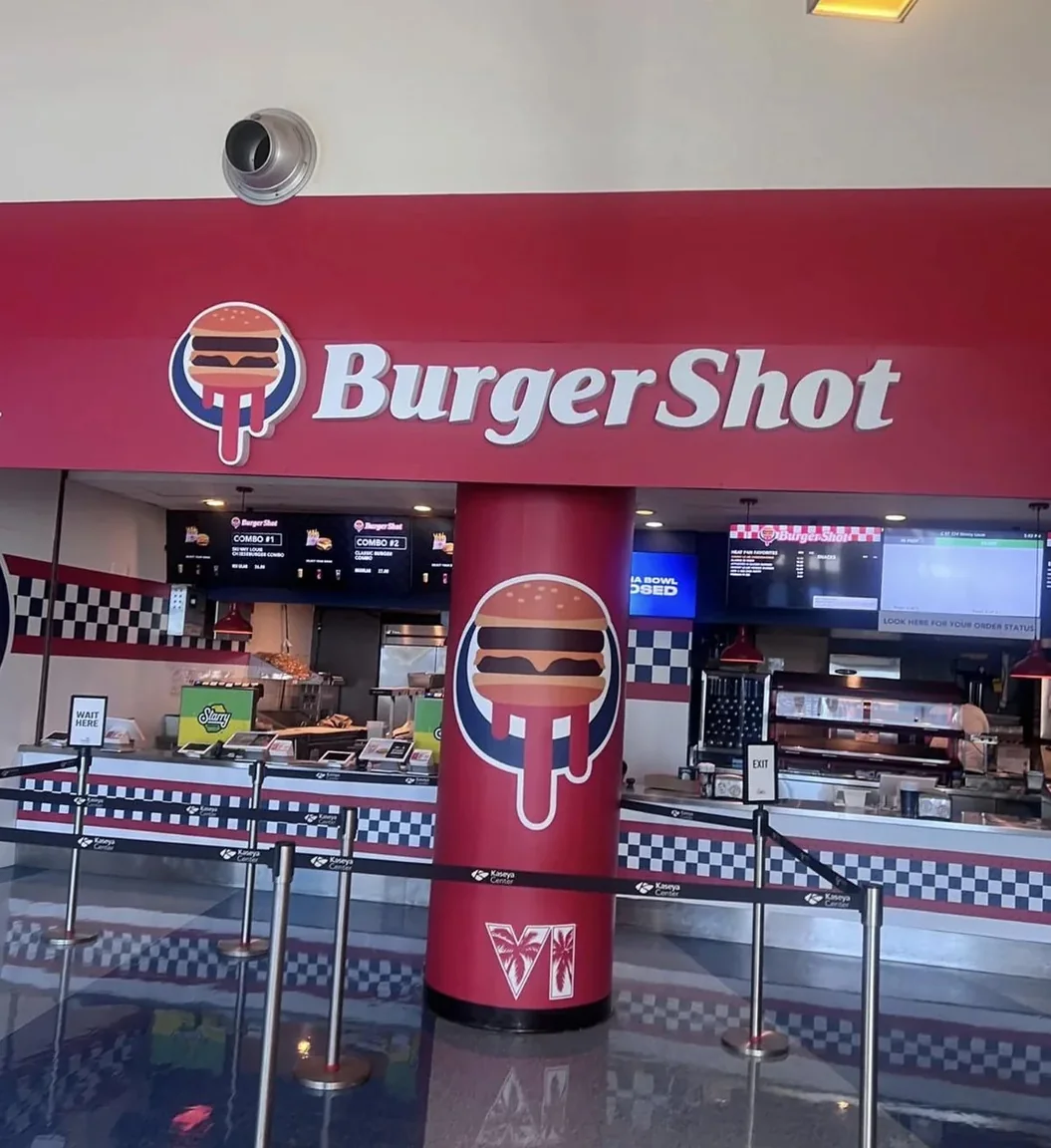 The Burger Shot concession stand at the Kaseya Center with branded column and menu screens