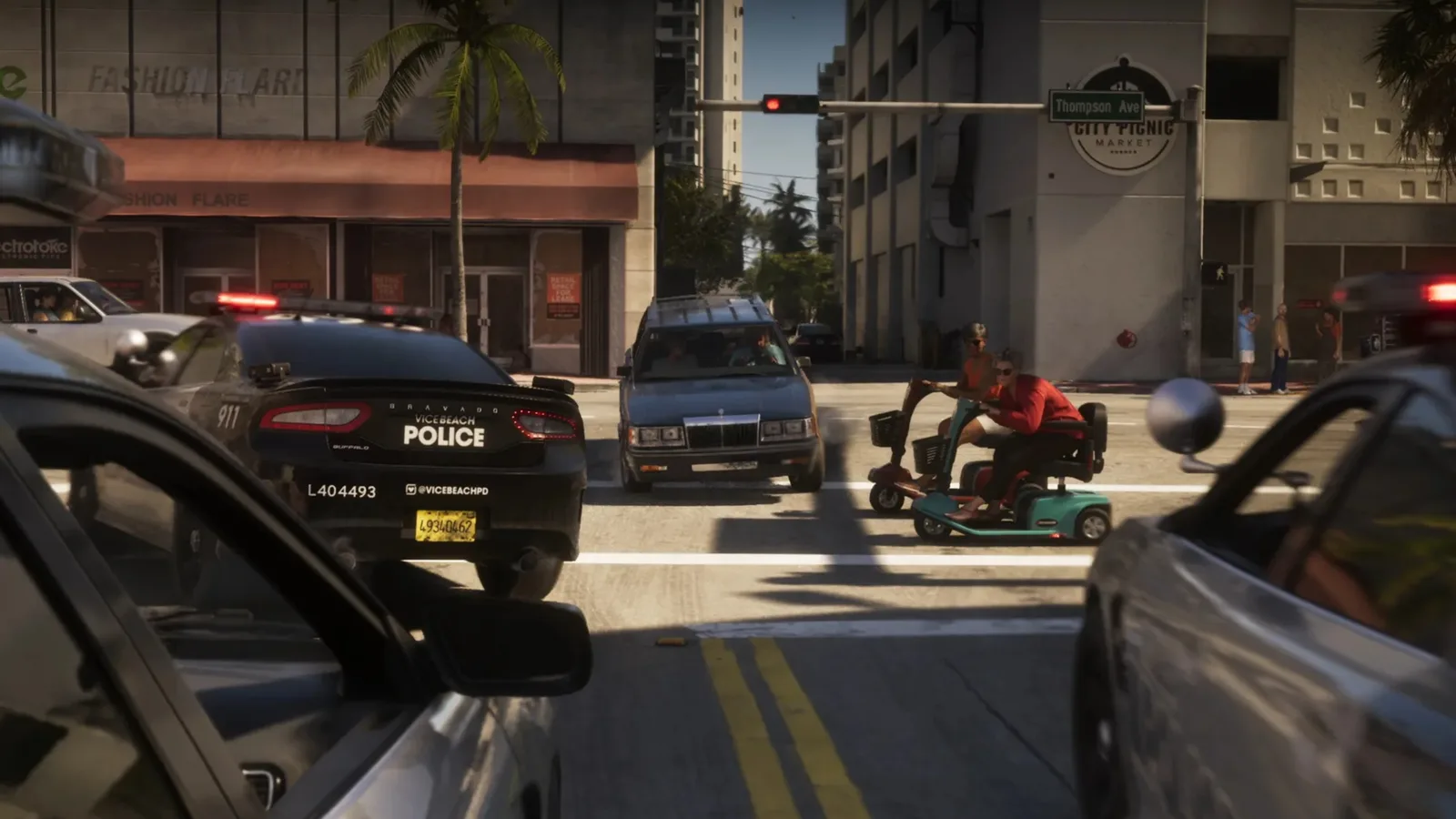 A Vice City police cruiser waiting in traffic at a palm-lined intersection in GTA 6