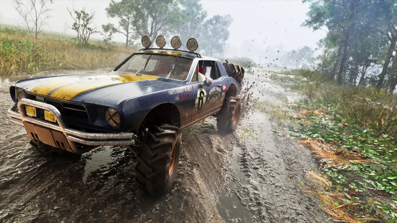 A battered rally coupe with roof lights throwing mud across a wet forest trail in GTA 6