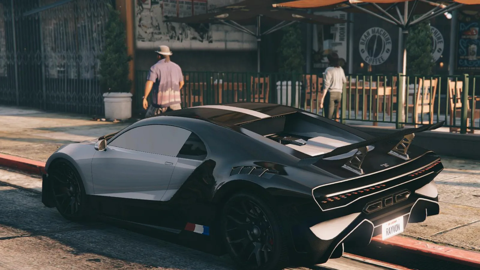 A black and silver Truffade Thrax hypercar parked kerbside outside a coffee shop in GTA Online
