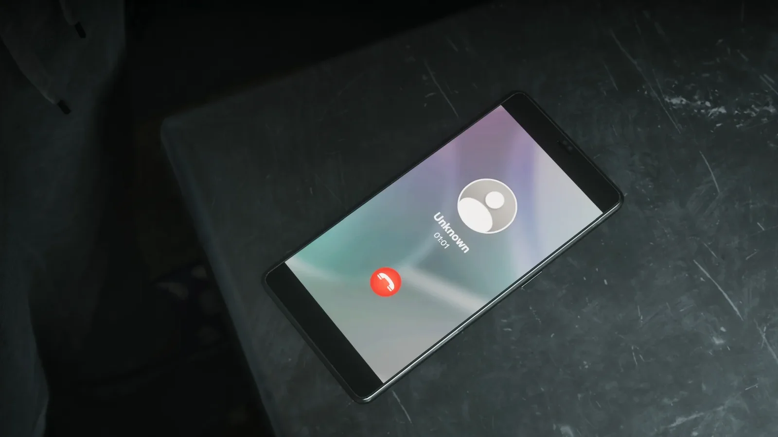 A phone on a dark table showing an incoming call from an unknown number in GTA 6