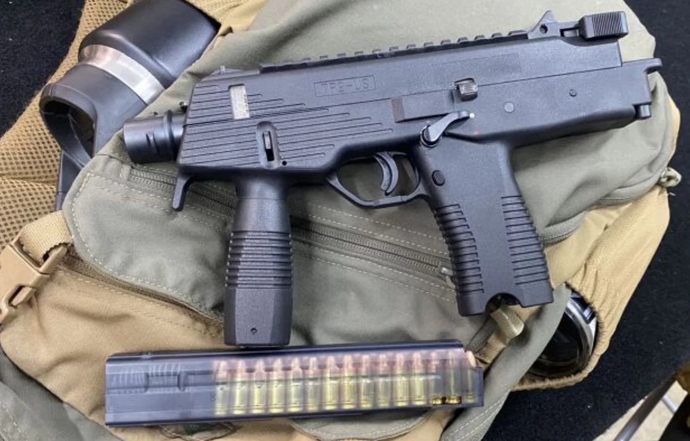 Steyr SPP machine pistol on a range bag beside a loaded magazine, one of the two candidates behind the GTA 6 SPP / MP9.